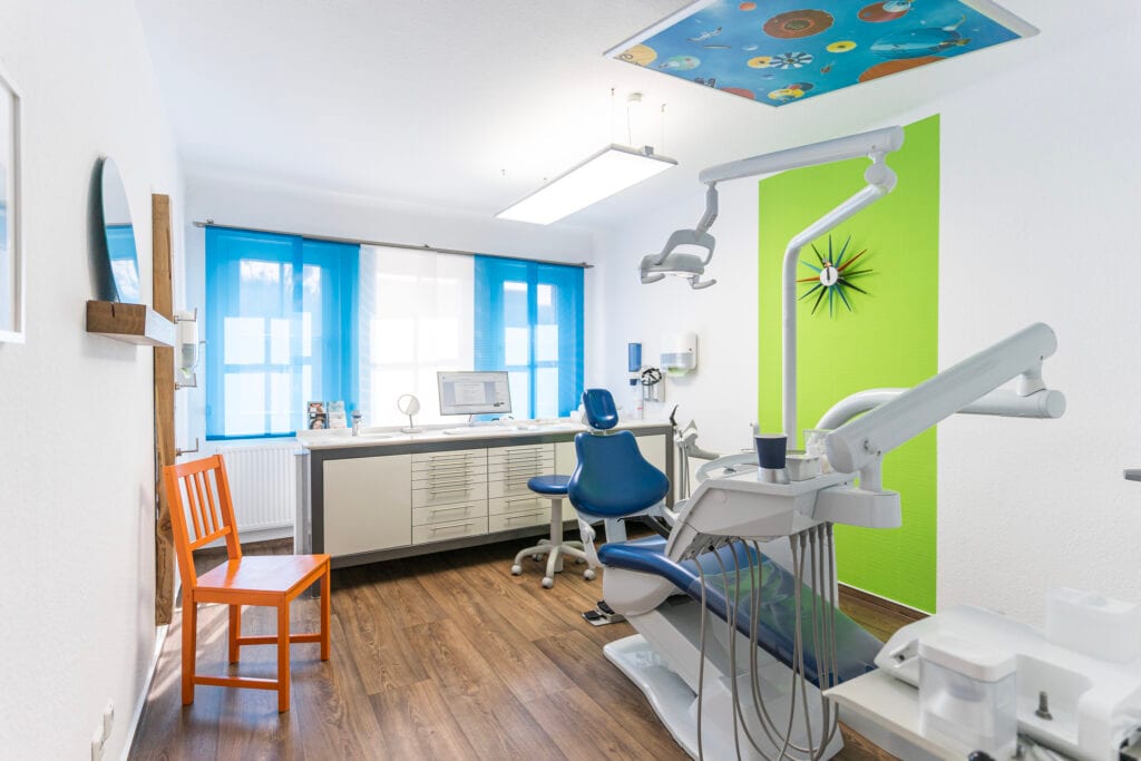 Zahnarztpraxis mit moderner Einrichtung und farbenfroher Dekoration.
